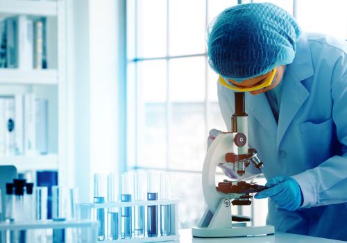 Scientist looking through a microscope.