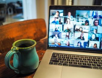 Coffee mug next to computer