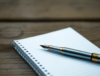 A pen and pad of paper