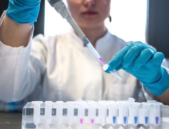 Laboratory image with a person pipetting