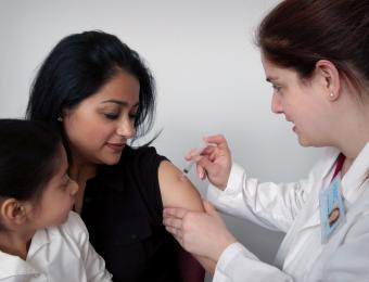 Healthcare worker giving a vaccination to another person